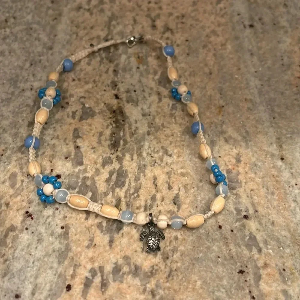 Kids beaded necklace with a silver turtle at the bottom of the necklace